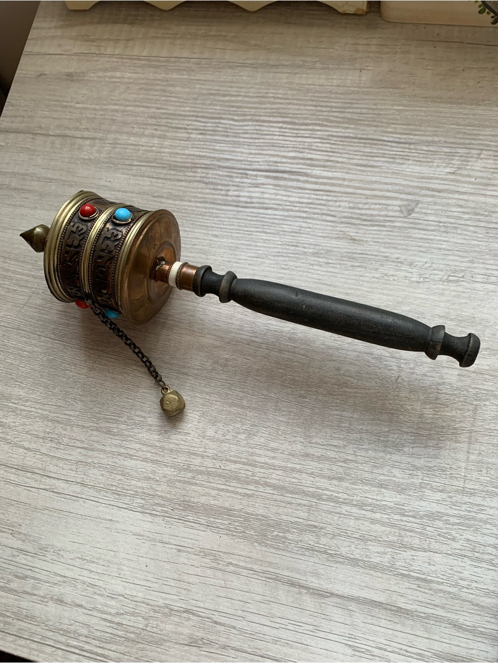 BrassTibetan Prayer Wheel with Black Wooden Handle filled with a prayer scroll